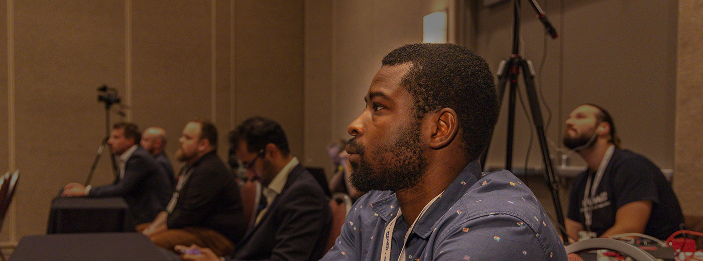 Conference attendee listens intently to the speaker