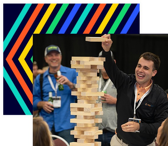 Gentleman plays Jenga at the Welcome Reception for Advanced Manufacturing Minneapolis